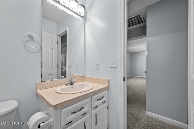 bathroom with vanity, ceiling fan, and toilet