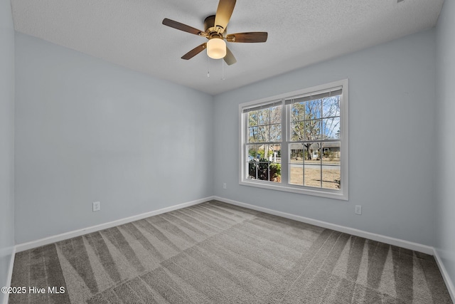 unfurnished room with ceiling fan, carpet floors, and a textured ceiling