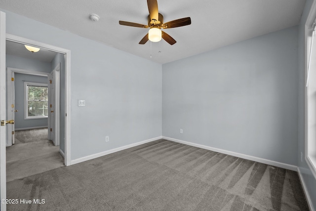 empty room featuring carpet floors and ceiling fan