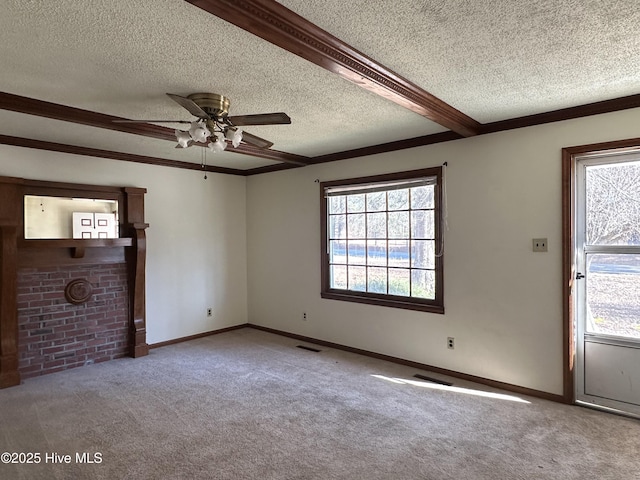 spare room featuring ceiling fan, light colored carpet, a fireplace, beamed ceiling, and a textured ceiling