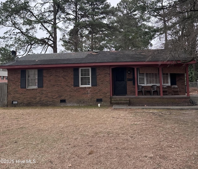 ranch-style house with fence, covered porch, roof with shingles, and crawl space