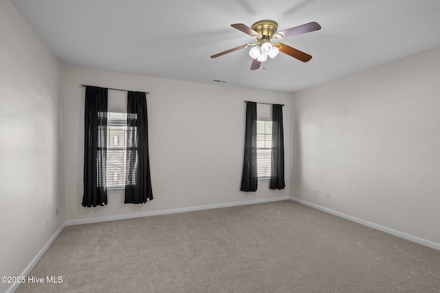 carpeted empty room featuring ceiling fan