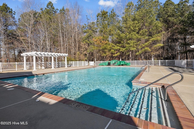 view of swimming pool with a pergola and a patio