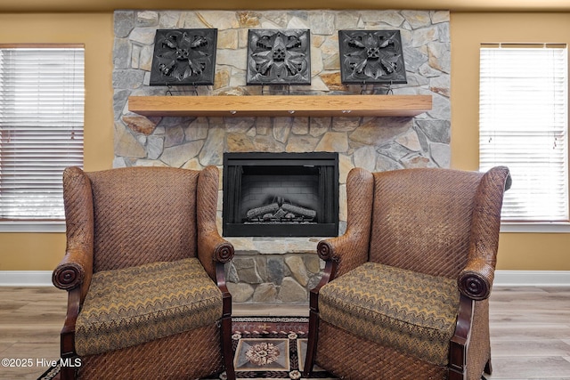 living area featuring a fireplace, a wealth of natural light, and hardwood / wood-style floors