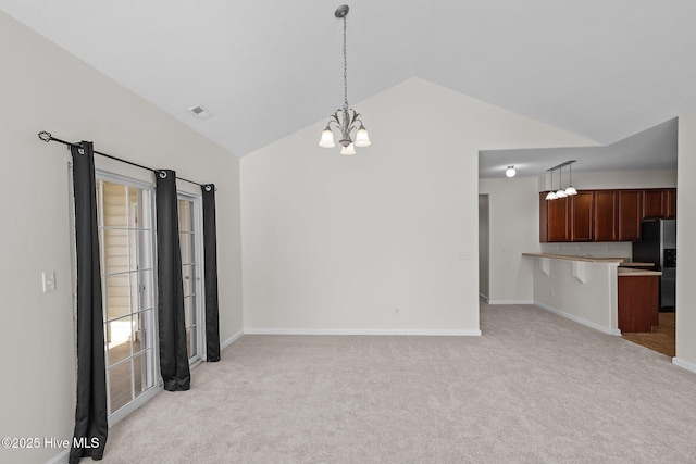 interior space with lofted ceiling, light colored carpet, and a notable chandelier