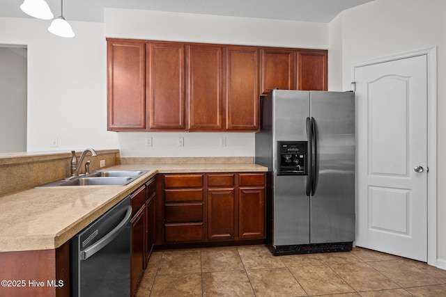 kitchen with decorative light fixtures, black dishwasher, sink, stainless steel fridge, and light tile patterned floors