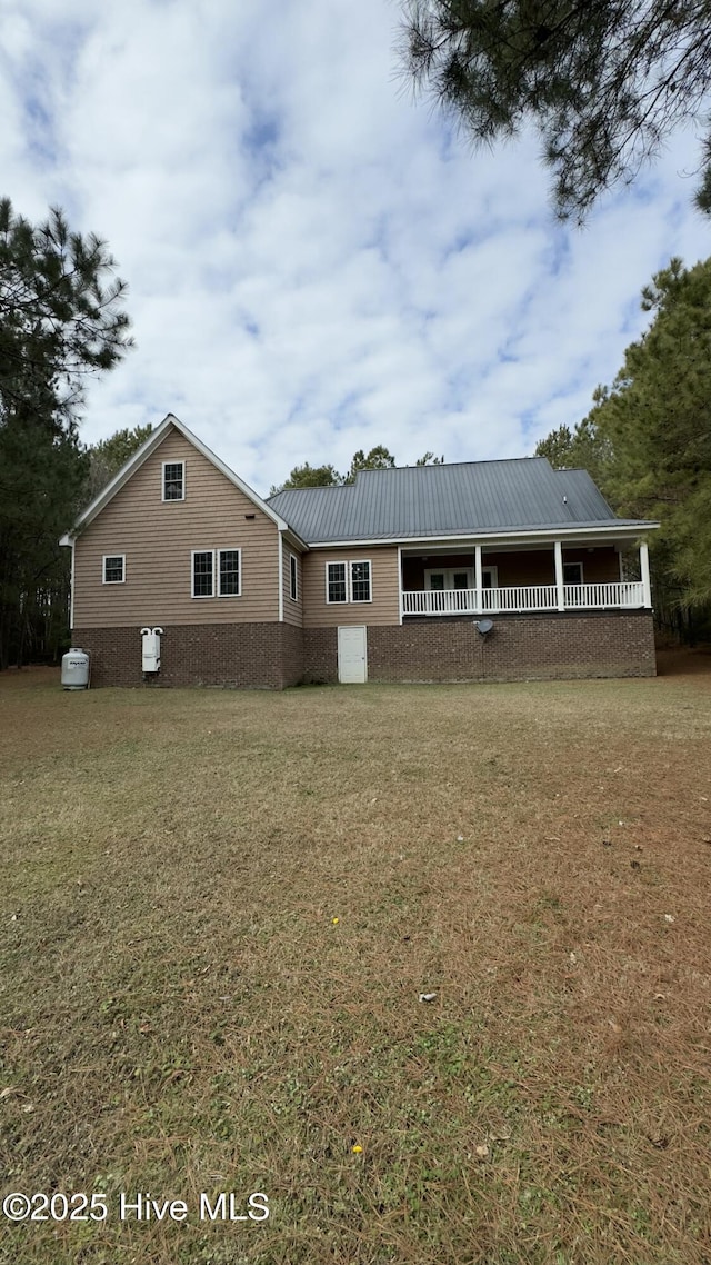 rear view of house with a yard