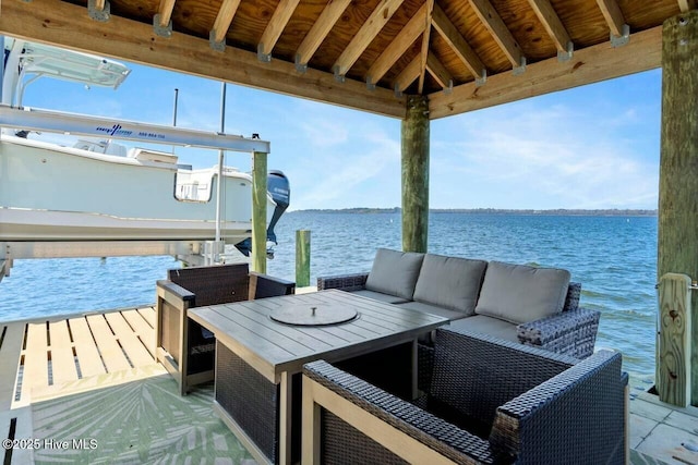 view of dock with an outdoor hangout area, a gazebo, and a water view