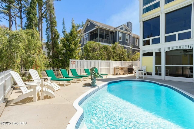 view of swimming pool with ceiling fan and a patio area