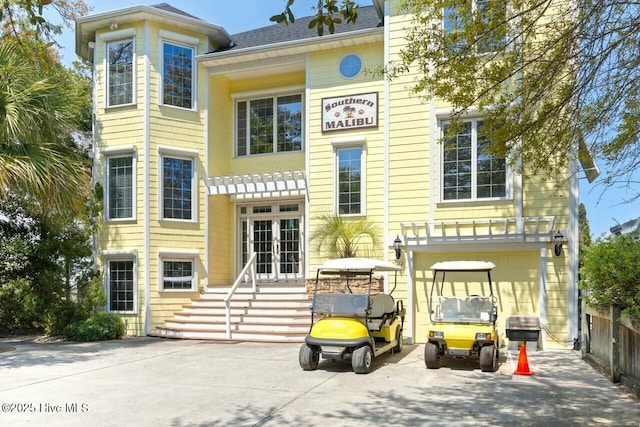 rear view of property featuring french doors