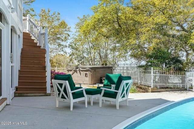 view of patio / terrace featuring a swimming pool with hot tub