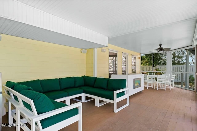 sunroom featuring ceiling fan