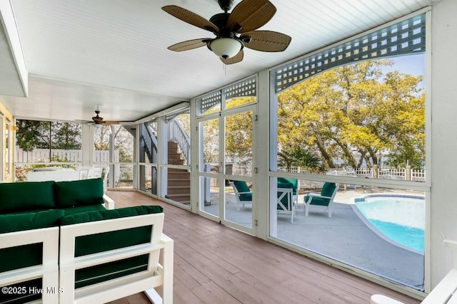 unfurnished sunroom with ceiling fan