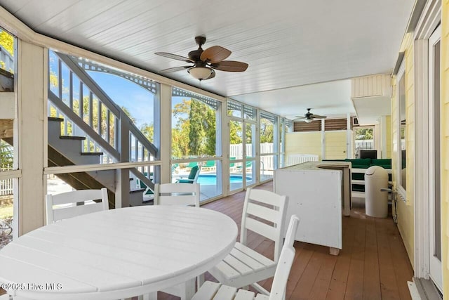 sunroom / solarium with ceiling fan and a healthy amount of sunlight