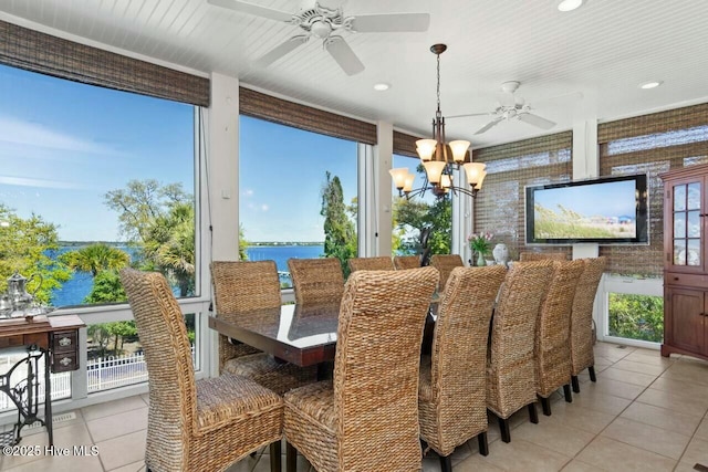 dining space featuring plenty of natural light, light tile patterned floors, and an inviting chandelier