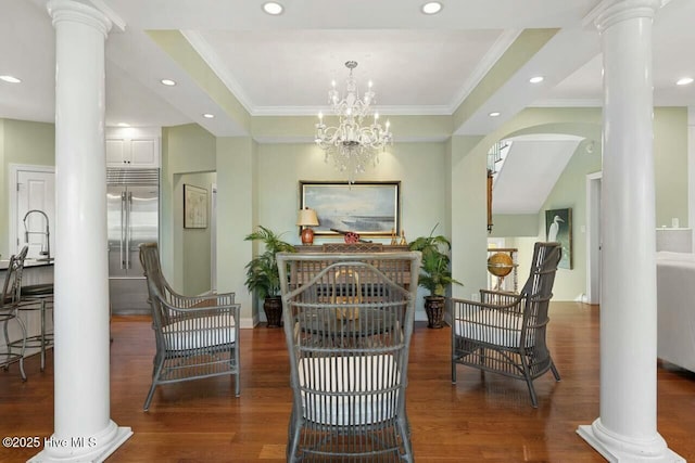 sitting room featuring an inviting chandelier, ornamental molding, and decorative columns