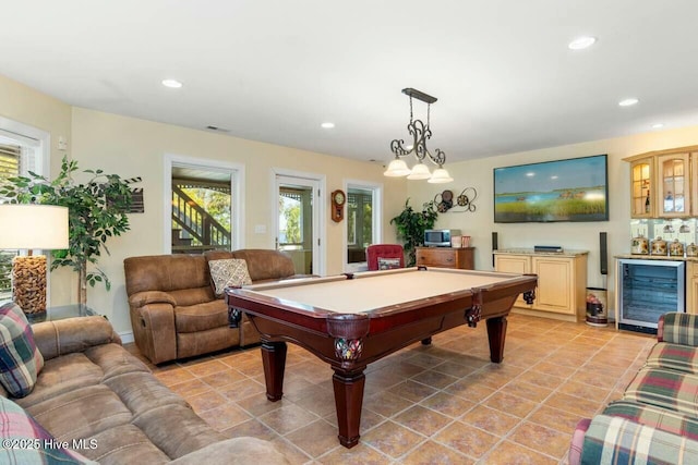 playroom featuring wine cooler, bar area, pool table, and a healthy amount of sunlight