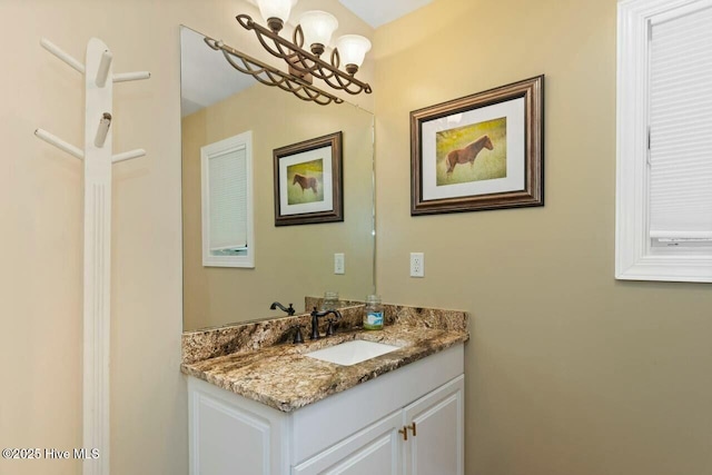 bathroom featuring an inviting chandelier and vanity