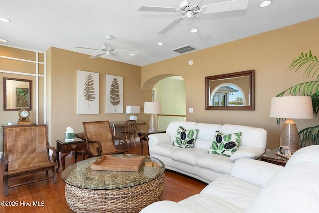 living room with ceiling fan and dark hardwood / wood-style floors