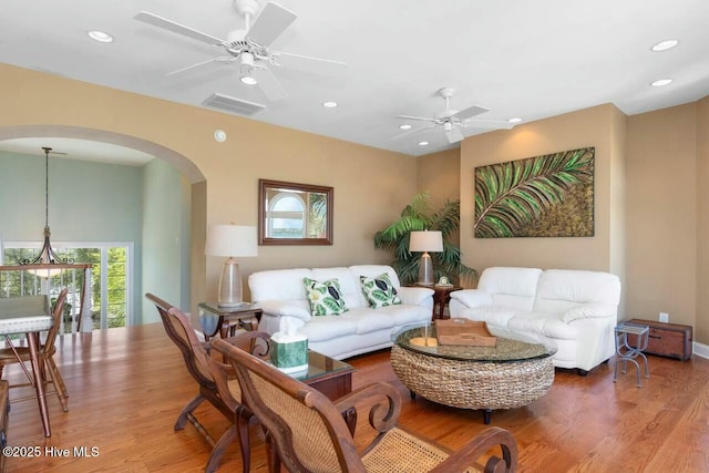 living room featuring ceiling fan and hardwood / wood-style floors