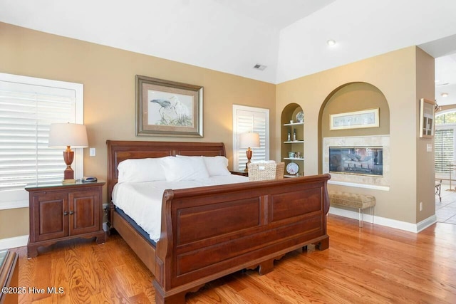 bedroom featuring vaulted ceiling and light hardwood / wood-style flooring