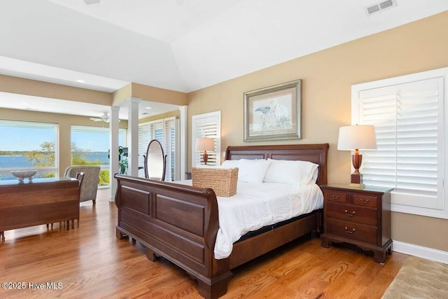 bedroom with vaulted ceiling and light hardwood / wood-style flooring