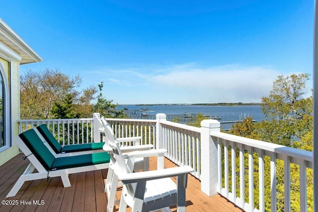 wooden terrace featuring a water view