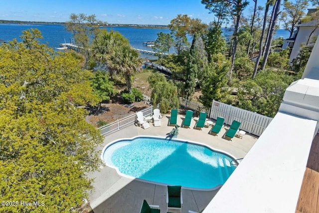 view of pool featuring a water view and a patio