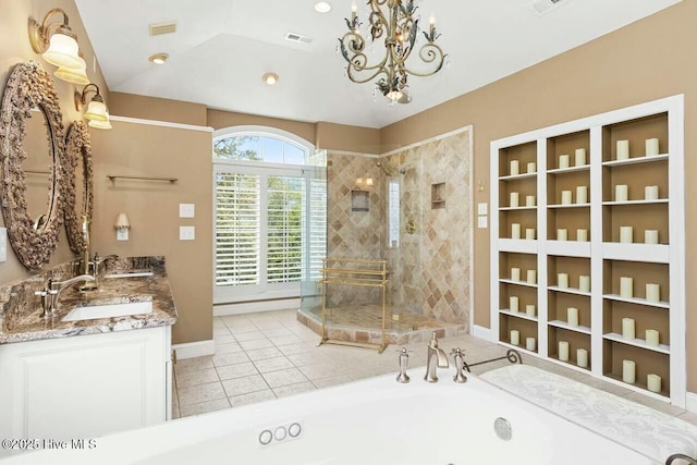 bathroom featuring tile patterned floors, vanity, separate shower and tub, and a notable chandelier