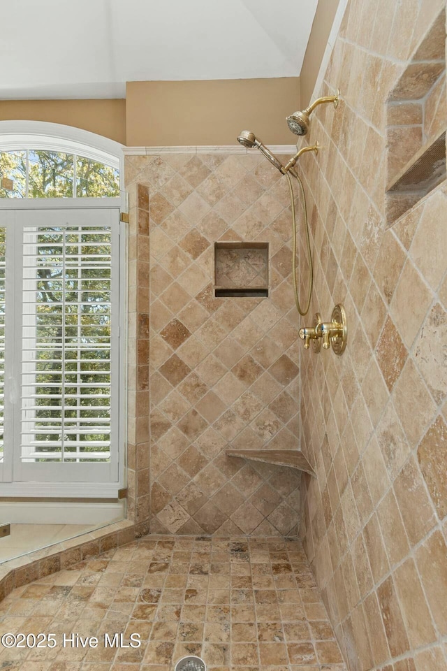 bathroom with tiled shower