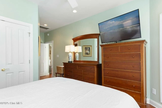 bedroom featuring ceiling fan, hardwood / wood-style floors, and a closet