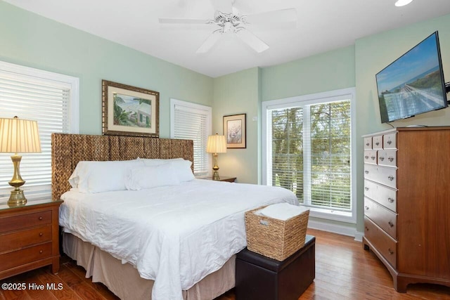 bedroom featuring ceiling fan and dark hardwood / wood-style floors