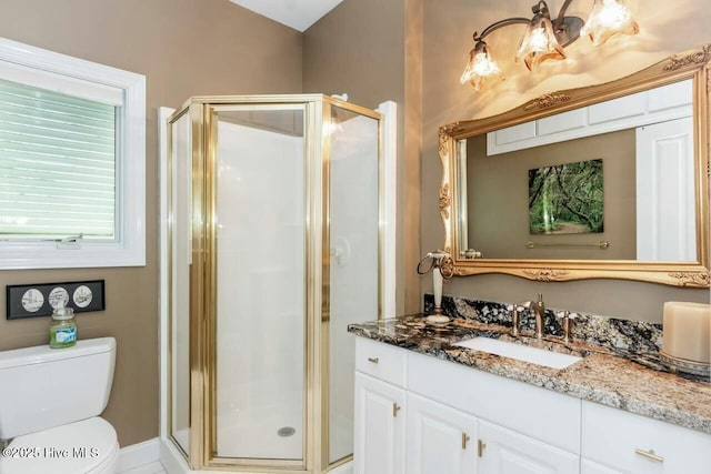 bathroom with an enclosed shower, vanity, and toilet