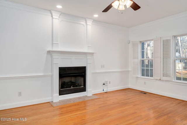 unfurnished living room featuring crown molding, light hardwood / wood-style floors, and ceiling fan