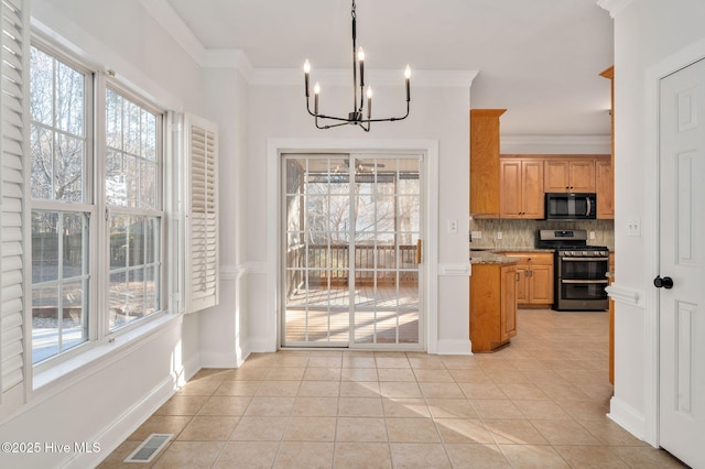 tiled dining room featuring sink, a wealth of natural light, and ornamental molding