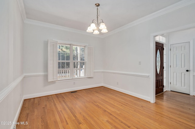 dining space featuring an inviting chandelier, ornamental molding, and light hardwood / wood-style flooring