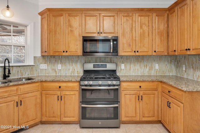 kitchen with crown molding, decorative light fixtures, dishwasher, and light stone counters