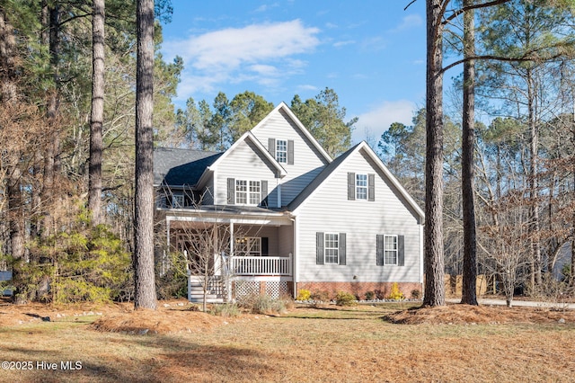 front facade with a front lawn and covered porch