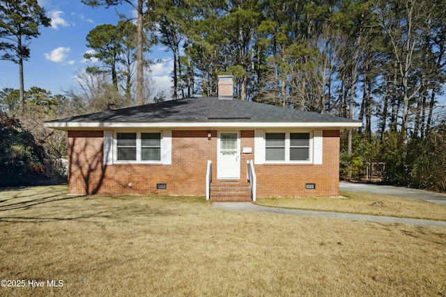 view of front facade featuring brick siding, crawl space, a chimney, and a front lawn