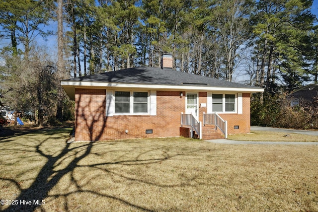 view of front of house featuring brick siding, crawl space, a chimney, and a front yard