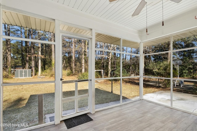 unfurnished sunroom with ceiling fan