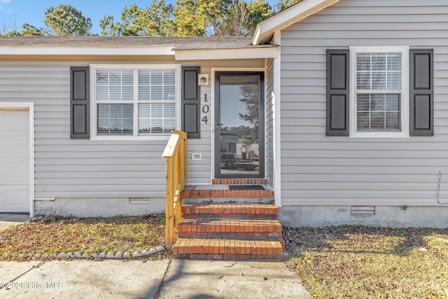 doorway to property featuring a garage