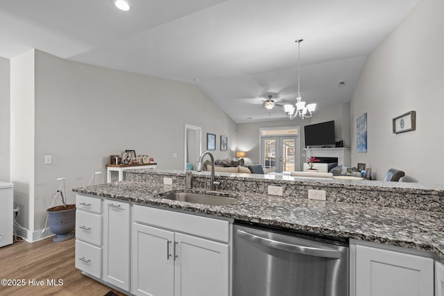 kitchen featuring sink, white cabinetry, dark stone counters, and dishwasher