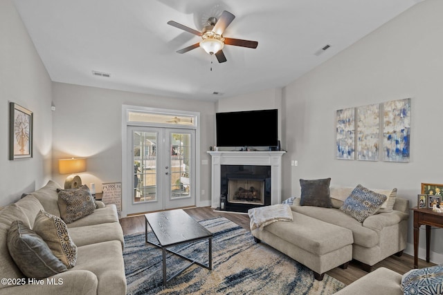 living room with hardwood / wood-style flooring, ceiling fan, and french doors