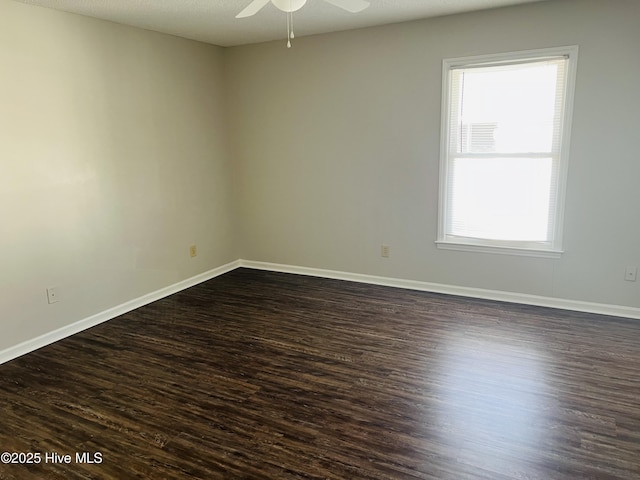 spare room with ceiling fan, dark hardwood / wood-style floors, and a textured ceiling