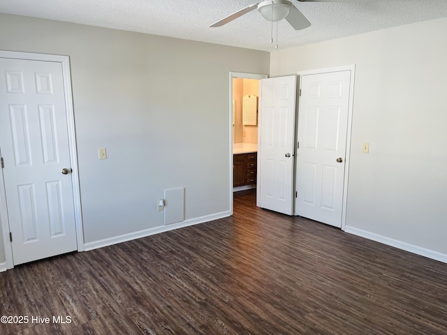 unfurnished bedroom with a textured ceiling, dark hardwood / wood-style floors, and ceiling fan