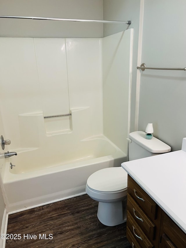 full bathroom with vanity, wood-type flooring, shower / bathtub combination, and toilet