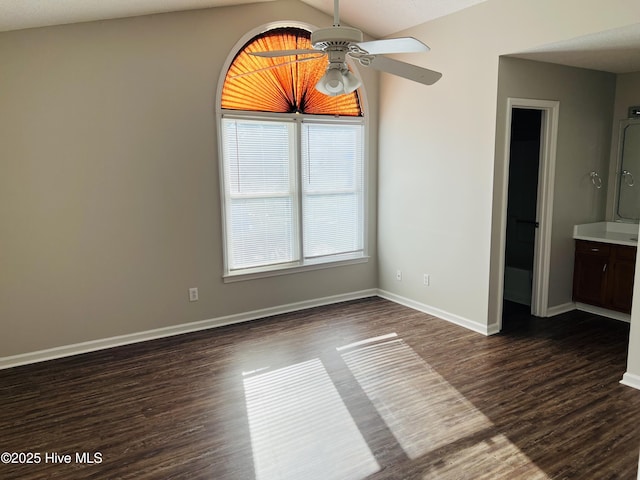 interior space with lofted ceiling, dark hardwood / wood-style floors, and ceiling fan