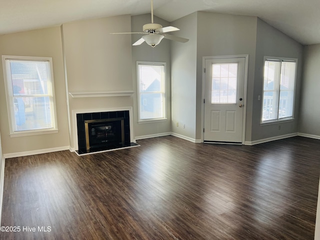 unfurnished living room featuring dark hardwood / wood-style flooring, a fireplace, lofted ceiling, and ceiling fan