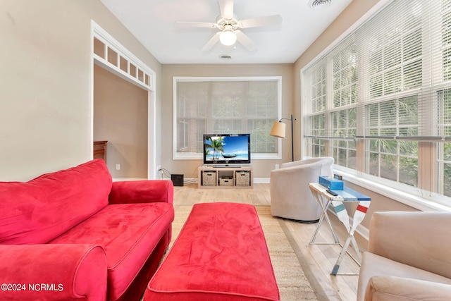 living room with ceiling fan and wood-type flooring